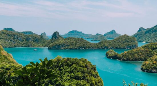 Crystal waters and limestone cliffs in Ang Thong for an Ang Thong Tours banner with Legend Travel Group.